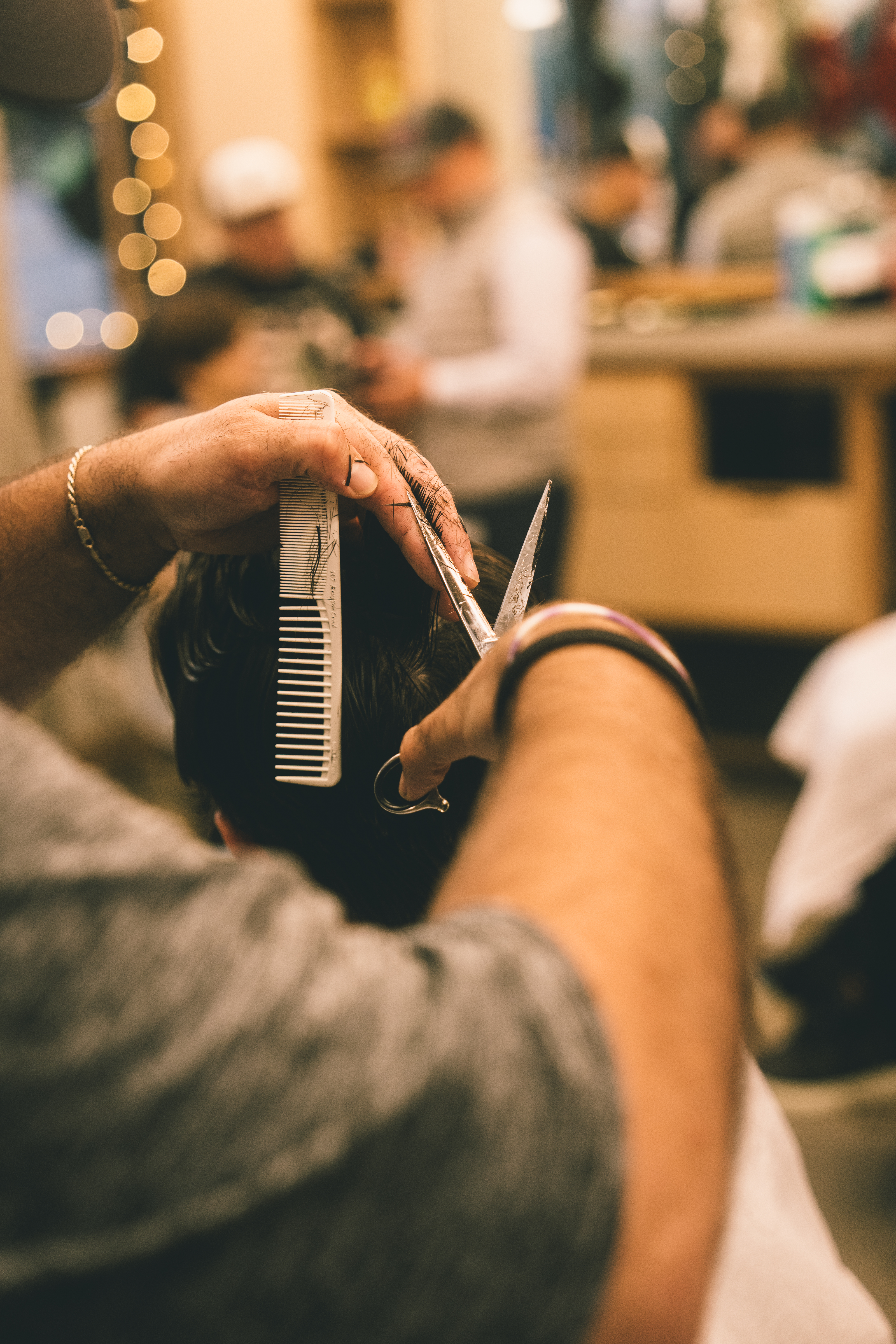 Cam at work in the barbershop with a client