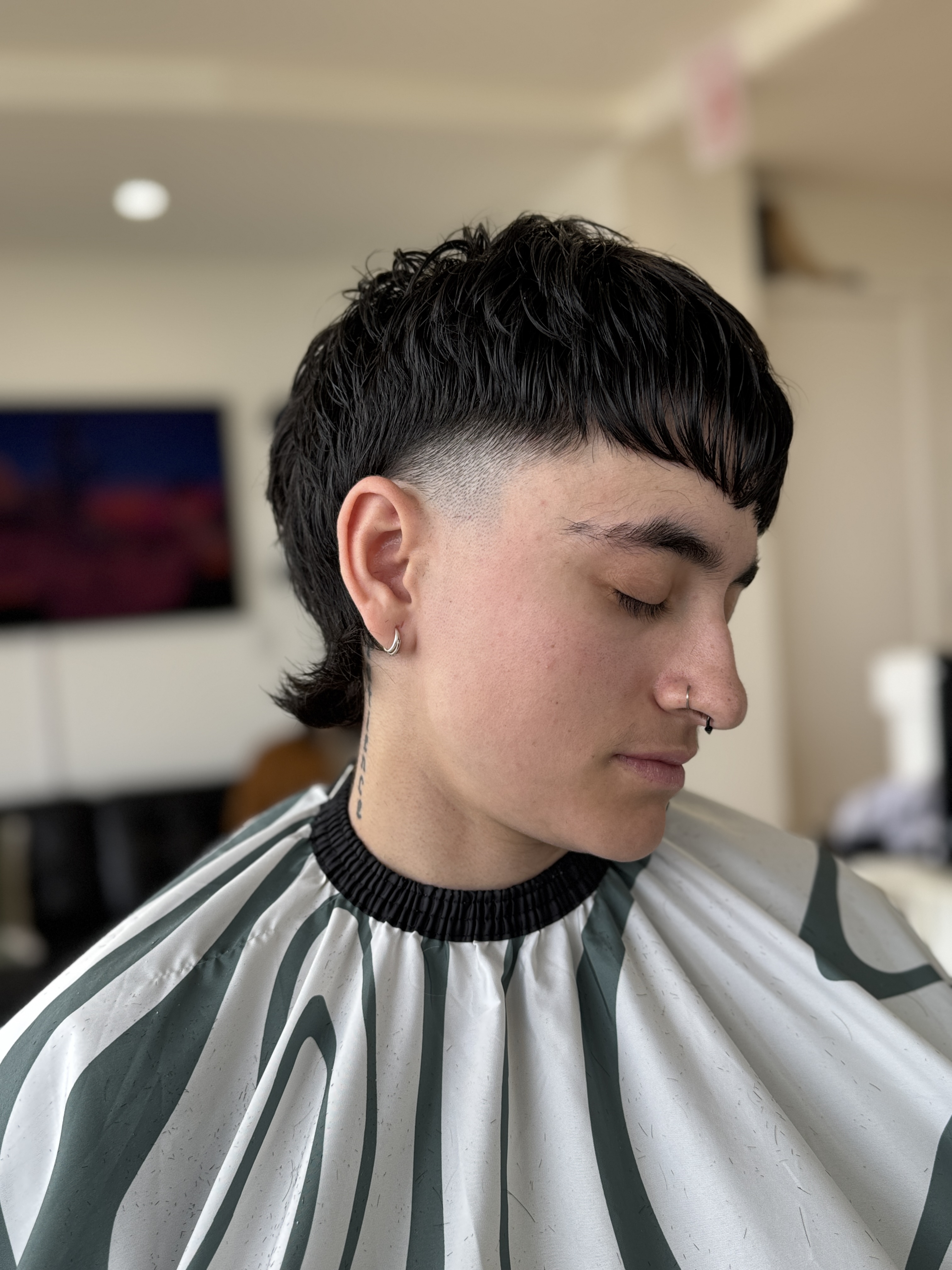 Cam working on textured curly hair in the barbershop